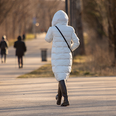 The audio captures the rhythmic sound of footsteps and the rustling noise of a jacket, possibly due to the person's movement.